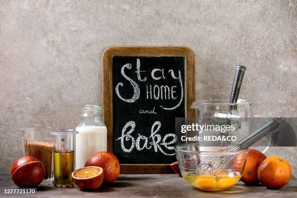 Ingredients for baking. Stay home quarantine isolation period concept. Vintage chalkboard with handwritten chalk lettering Stay home and bake. Grey...
