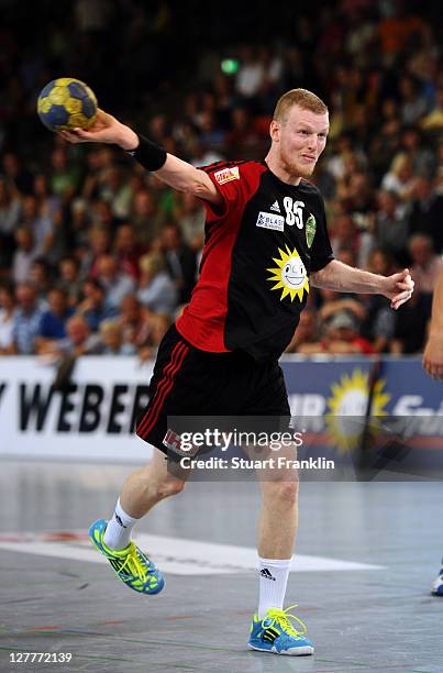 Tim Remer of Luebbecke throws a goal during the Toyota Handball Bundesliga match between TuS N-Luebbecke and Eintracht Hildesheim on October 1, 2011...