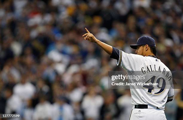 Yovanni Gallardo of the Milwaukee Brewers signals to his left fielder Ryan Braun after throwing out Willie Bloomquist of the Arizona Diamondbacks at...