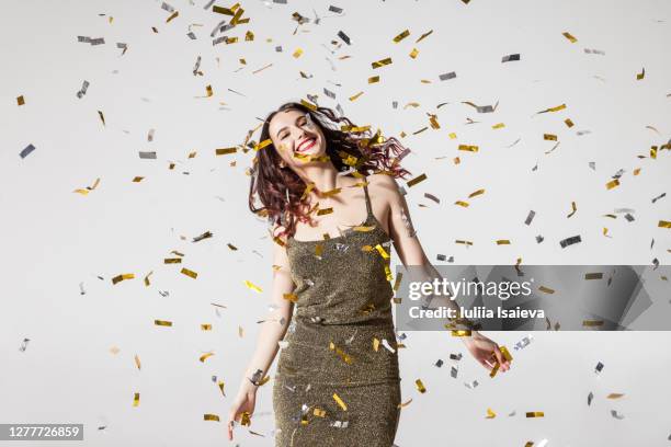 delighted woman dancing under confetti - fashion fest 2019 stock-fotos und bilder