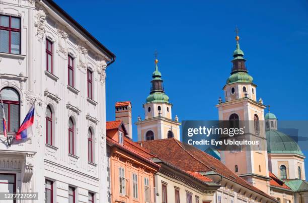 Slovenia, Ljubljana, Mestni trg streetscape with towers and dome of the Cathedral of St Nicholas in the background.