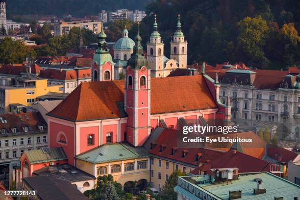 Slovenia, Ljubljana, Vista of the city from the 12th floor viewing terrace of the Neboticnik or Skyscraper Building with the Franciscan Church of the...