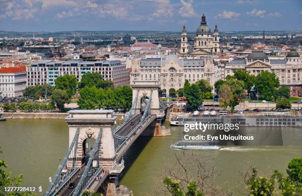 Hungary, Budapest, Szechenyi Chain Bridge across the River Danube with St Stephens Basilica as seen from Castle Hill.