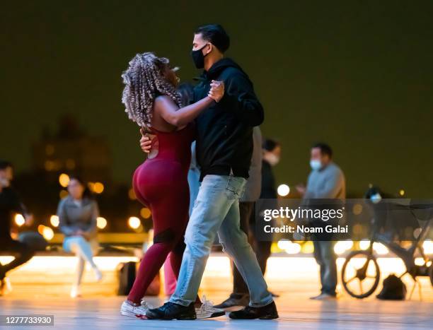 People wear face masks while taking a dance class in the South Street Seaport as the city continues Phase 4 of re-opening following restrictions...