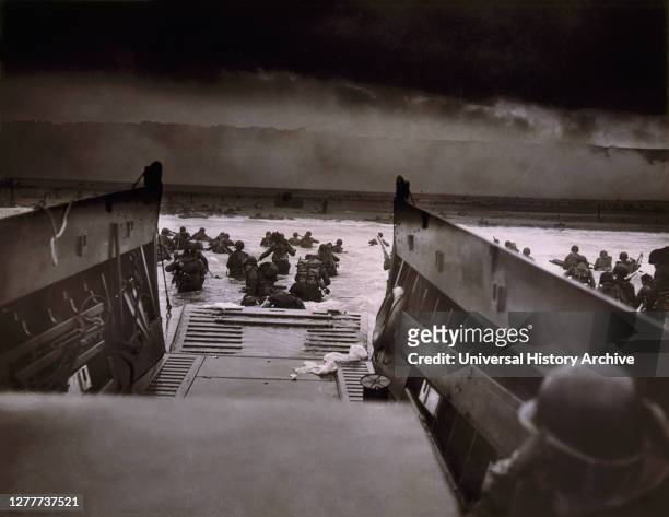 American Soldiers wading from Coast Guard landing barge toward Beach at Normandy, France on D-Day, Robert F. Sargent, June 6, 1944.