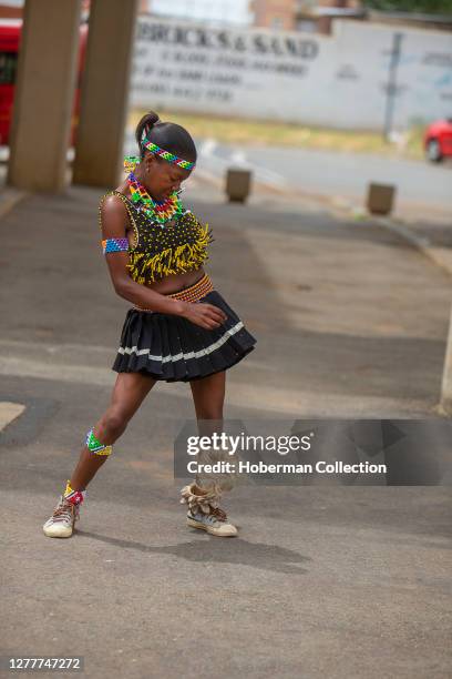 Young African girl performing traditional Zulu dance in Soweto township, South Africa