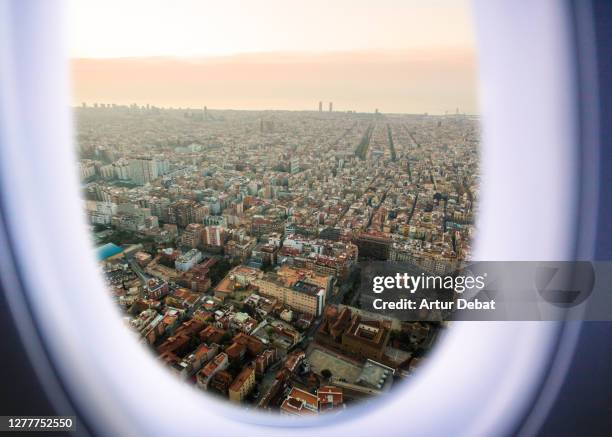 airplane window view from passenger point of view of the barcelona cityscape. - barcelona cityscape stock pictures, royalty-free photos & images