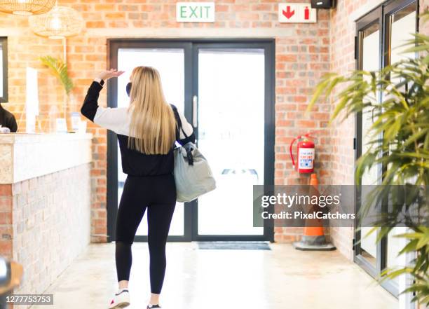 teenager wearing mask waving leaving gym - gym reopening stock pictures, royalty-free photos & images
