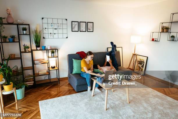 young couple living in eco-friendly smart home and working remotely - tenant stock pictures, royalty-free photos & images