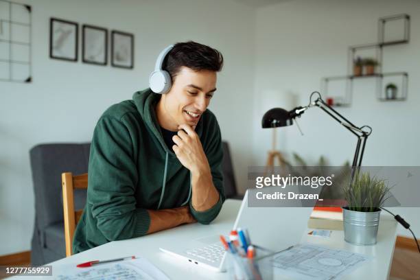 working and studying from home. vlogger in front of laptop - young men stock pictures, royalty-free photos & images