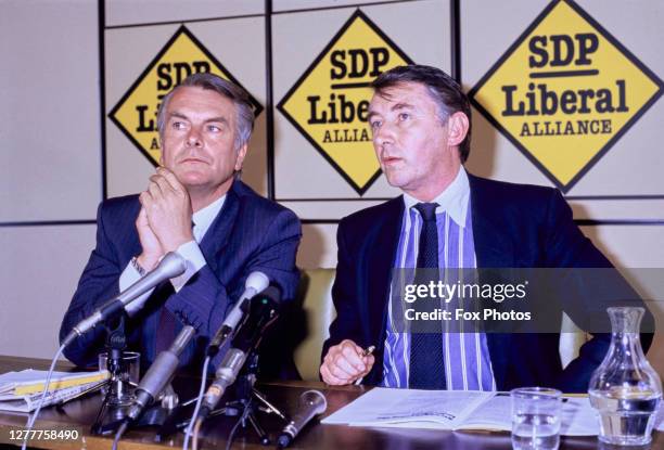 British politicians David Owen, leader of the Social Democratic Party, and David Steel, leader of the Liberal Party, hold an SDP-Liberal Alliance...