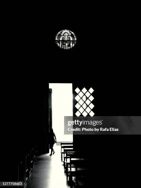 mysterious woman entering into the church - abstract geometric silhouette woman stock pictures, royalty-free photos & images