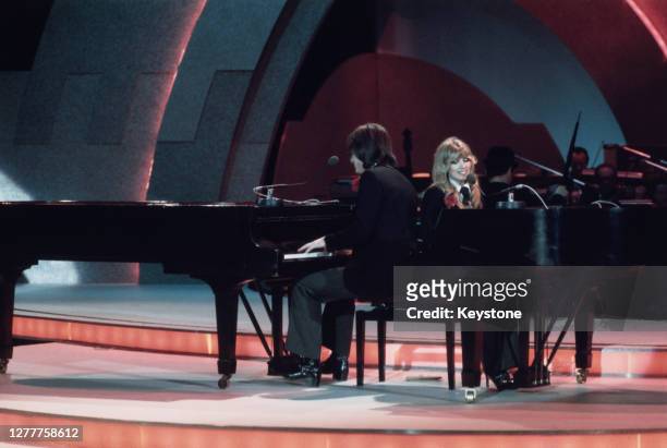 English singer-songwriter Lynsey de Paul duets with songwriter Mike Moran at the Eurovision Song Contest, performing their song 'Rock Bottom',...