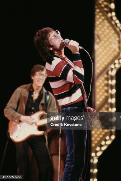 British pop singer Cliff Richard performs with guitarist Hank Marvin of the Shadows at a Royal Variety Performance rehearsal at the Theatre Royal on...
