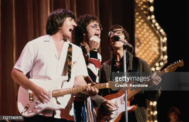 British pop singer Cliff Richard performs with guitarists Bruce Welch and Hank Marvin of the Shadows at a Royal Variety Performance rehearsal at the...