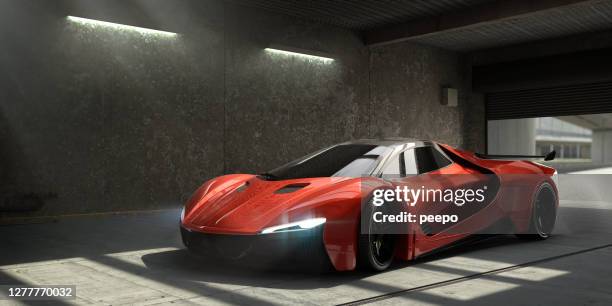 generic red sports car parked in empty garage - futuristic car stock pictures, royalty-free photos & images