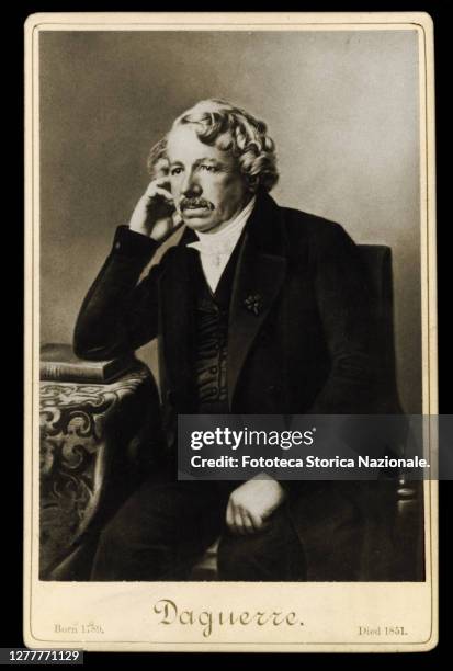 Louis Jacques Mandé Daguerre portrait sitting at the table with his elbow resting on a book. France, approx. 1850.