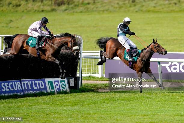 Harry Cobden riding Getaway Trump clear the last to win The Join Racing TV Now Beginners' Chase from Richard Johnson and Zoffee at Warwick Racecourse...