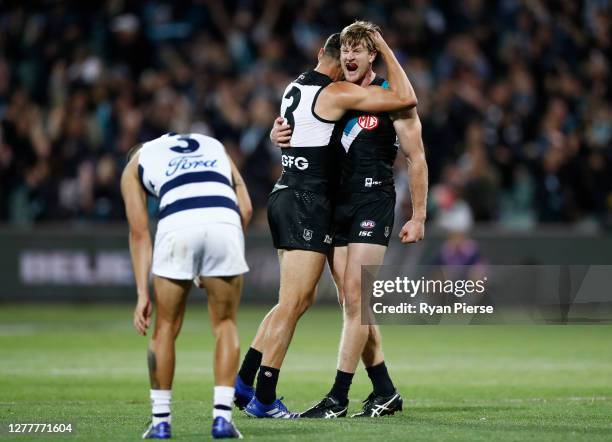 Tom Jonas of the Power and Ryan Burton of the Power celebrate after defeating the Cats during the AFL First Qualifying Final match between the Port...