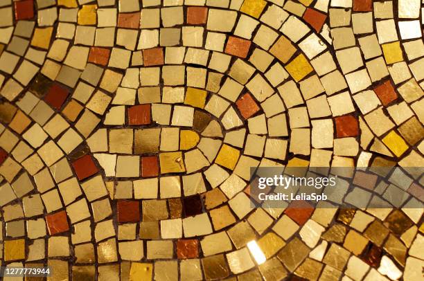 fragment of mosaic on the wall of a house in gold tones - sankt petersburg stock-fotos und bilder