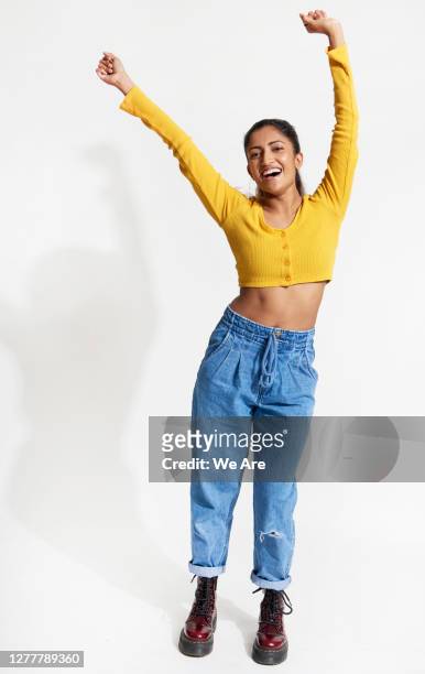 young woman dancing with hands in the air - full body isolated stockfoto's en -beelden