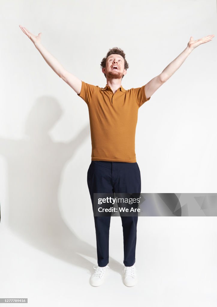 Man standing with arms outstretched
