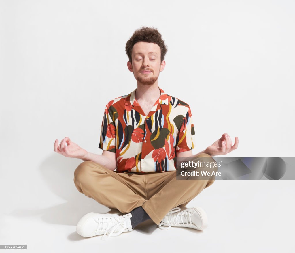 Young man sitting in mediation pose