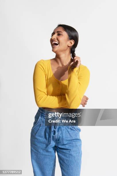 woman laughing holding braided hair - portrait isolated photos et images de collection