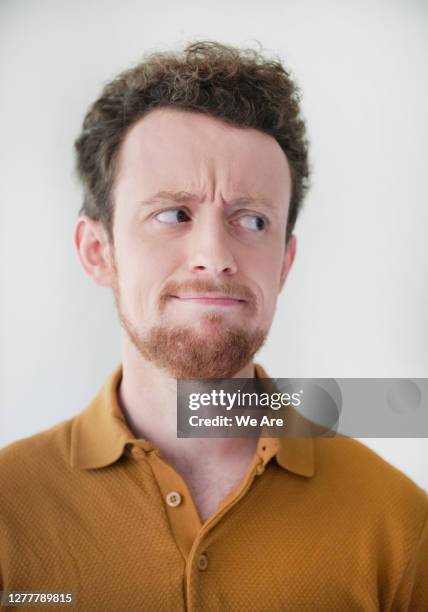 portrait of man with quizzical expression - frowning stock pictures, royalty-free photos & images