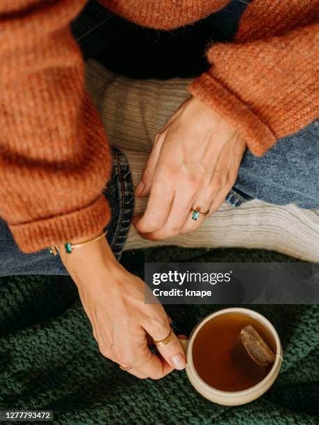 woman drinking tea indoors photo taken from above overhead - cup of tea from above stock pictures, royalty-free photos & images