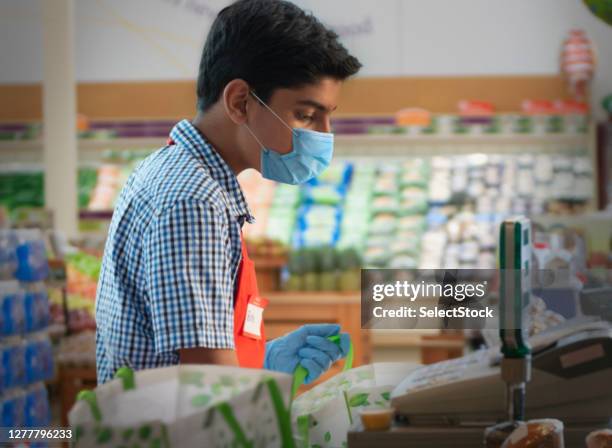 teenager working at supermarket - summer job stock pictures, royalty-free photos & images