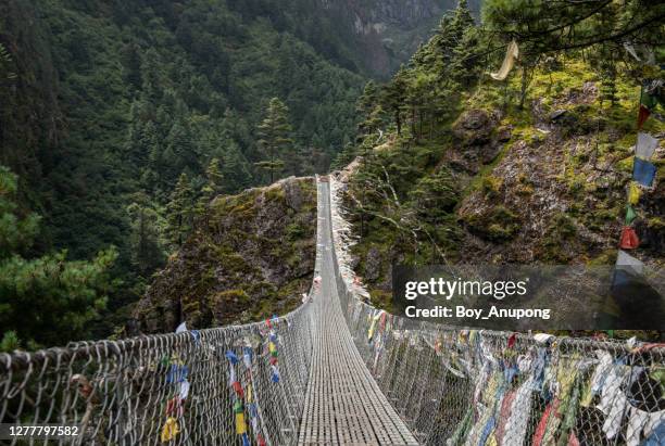 view on tenzing-hillary suspension bridge on the way to  namche bazaar, nepal. - tibetan culture stock pictures, royalty-free photos & images