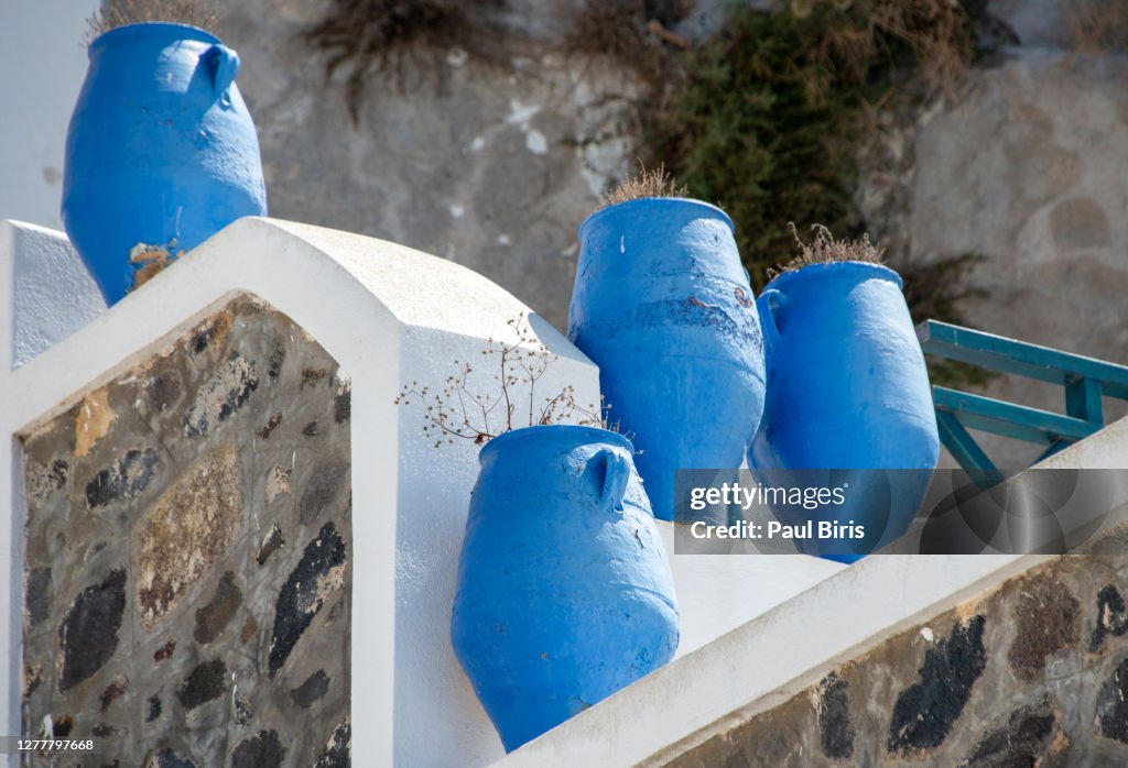Three deep blue Greek urn's on a patio , Fira, Santorini, Greece.