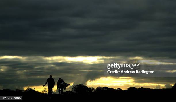 Matthew Southgate of England and caddie walk down the eighth hole during the first round of the Aberdeen Standard Investments Scottish Open at The...