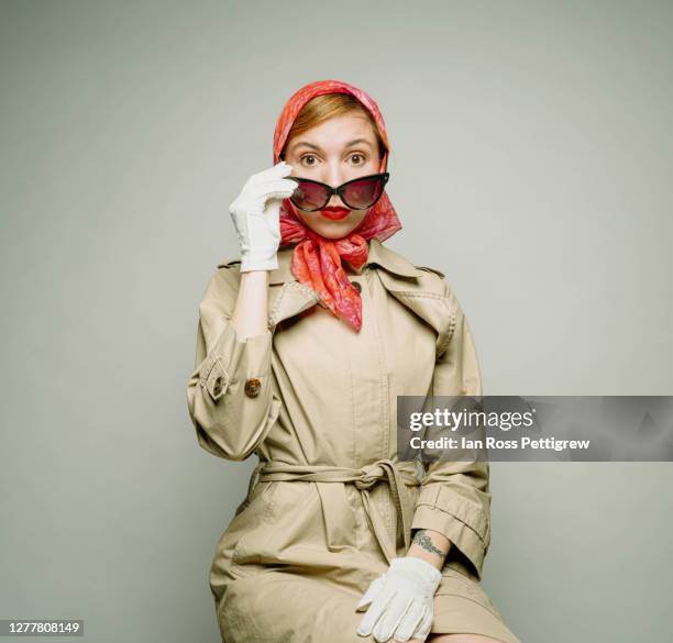 retro hipster woman wearing trench coat and kerchief on head - sunglasses disguise bildbanksfoton och bilder