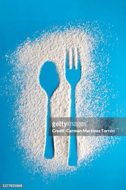 spoon and fork silhouette made with flour on blue background. - food photography dark background blue imagens e fotografias de stock