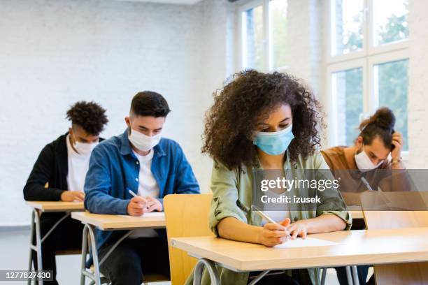 students at the lecture during coronavirus pandemic - students social distancing classroom stock pictures, royalty-free photos & images