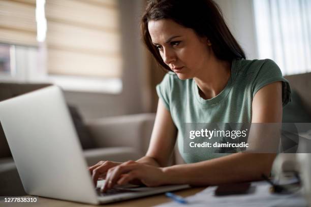 mature woman working at home - unemployment benefits stock pictures, royalty-free photos & images