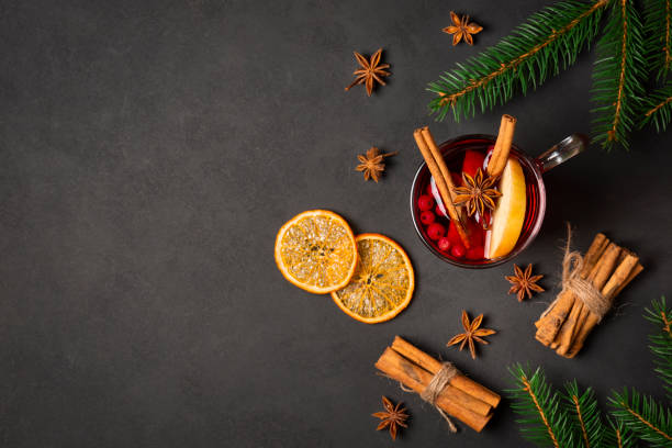 christmas flat lay background with cup of mulled red wine, fir tree, cinnamon, orange, spices and copy space - orange cocktail stock pictures, royalty-free photos & images