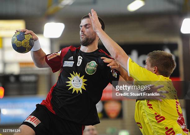 Drago Vukovic of Luebbecke is challenged by Michael Quist of Hildesheim during the Toyota Handball Bundesliga match between TuS N-Luebbecke and...