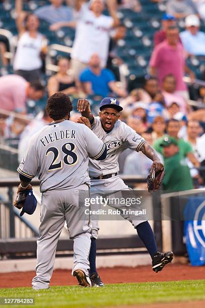 Prince Fielder of the Milwaukee Brewers reacts with Yuniesky Betancourt during the game against the New York Mets at Citi Field on August 20, 2011 in...