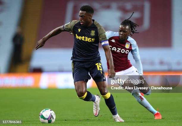 Bruno Martins Indi of Stoke City turns from Bertrand Traore of Aston Villa during the Carabao Cup fourth round match between Aston Villa and Stoke...