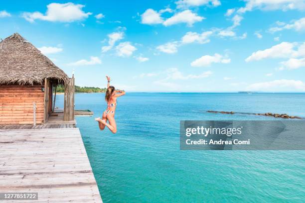 tourist jumping into caribbean sea. panama - peeple of caribbean stock-fotos und bilder