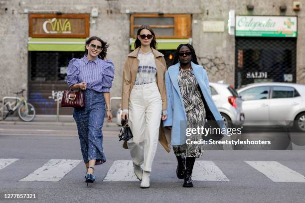 Influencer Sarah Lou Falk wearing a white blue striped blouse by Munthe, blue patterned pants by Munthe, blue heels by Custommade, a purple colored...