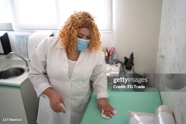 doctor cleaning gurney with alcohol using face mask - infection prevention imagens e fotografias de stock