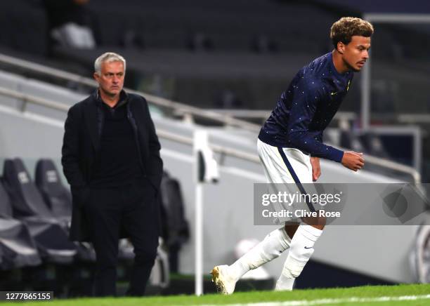 Jose Mourinho, Manager of Tottenham Hotspur looks on as Dele Alli of Tottenham Hotspur warms up at half time during the UEFA Europa League play-off...