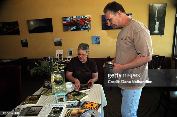 Author Patti Kreins talks with a fan at the booking signing for The Color of Angels at Caffe Ladro on June 4, 2011 in Edmonds, Washington.