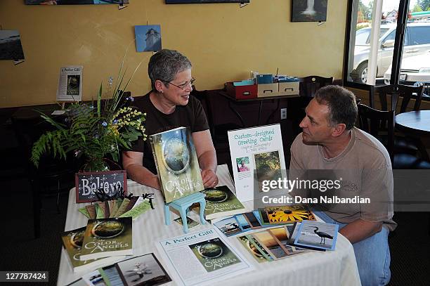 Author Patti Kreins talks with a fan at the booking signing for The Color of Angels at Caffe Ladro on June 4, 2011 in Edmonds, Washington.