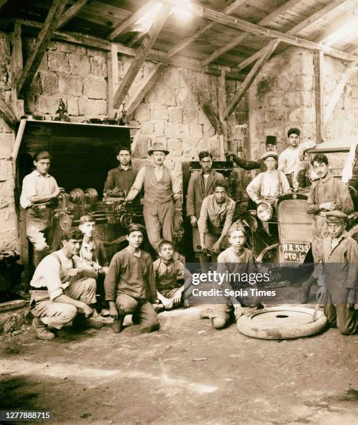 Staff in garage of American Colony Colony Buick Dodge Agency. Mechanics and others in the garage of the American Colony's Dodge Brothers automobile...