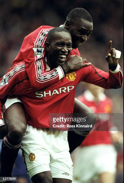 Dwight Yorke of Manchester United celebrates his goal with team mate Andy Cole during the FA Carling Premiership match against Wimbledon at Old...